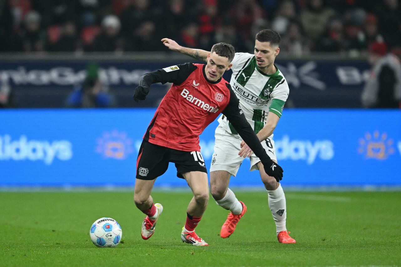 Bayer Leverkusen’s German midfielder Florian Wirtz (L) and Moenchengladbach’s German midfielder Julian Weigl vie for the ball during the German first division Bundesliga football match between Bayer Leverkusen and Borussia Moenchengladbach in Leverkusen, western Germany, on January 18, 2025.