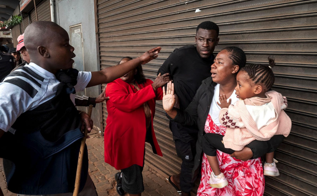 Protesters marched through the streets of the Johannesburg CBD, South Africa, on Tuesday, June 30, 2026. During the march, several people who were suspected by protesters of being foreign nationals were confronted by the crowd. A small gruop was shielded from assault by others who intervened and escorted them to safety. (Photo: Leon Sadiki)