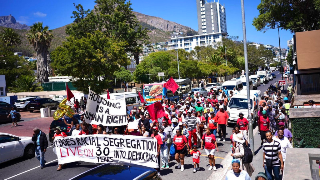 Activists from Reclaim the City march on 8 February 2024 in support of releasing the Tafelberg site in Sea Point for social housing development. (Photo: Supplied / Ndifuna Ukwazi)