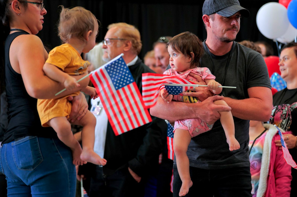 Newly arrived South Africans wait to hear welcoming statements from US government officials in a hangar at Atlantic Aviation Dulles near Washington Dulles International Airport on 12 May 2025. (Photo: Chip Somodevilla / Getty Images)
