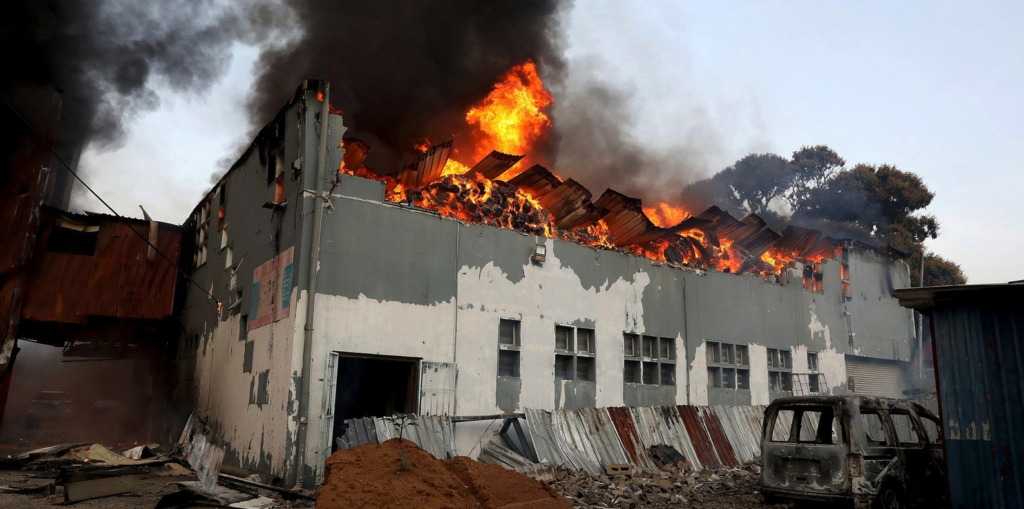 A business ablaze during the widespread looting and riots in Durban on 12 July 2021. (Photo: Stringer / EPA-EFE)