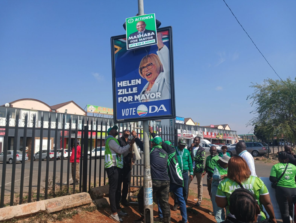 ActionSA supporters put up party posters on Thursday last week during the party's poster launch in Lenasia in the South of Johannesburg ahead of the November 4 Local Government Elections. (Photo: Bheki Simelane)